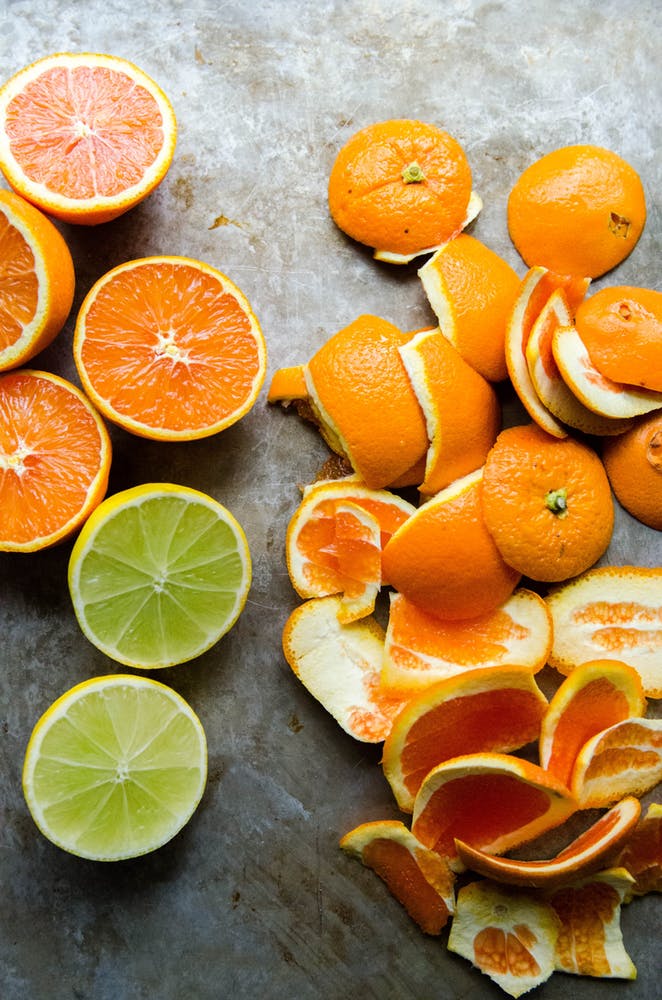 Oranges and lemons cut into half and their peels kept on one side on a grey slab- Who Who Carpet Cleaning Brisbane