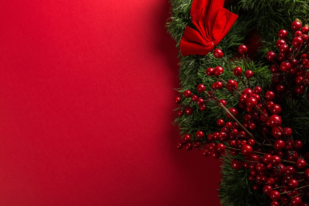 Bright Red Background with Christmas berries on one side